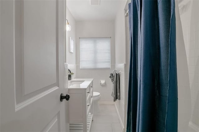 bathroom featuring vanity, tile walls, toilet, and a shower with curtain