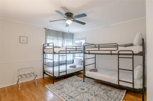 bedroom featuring wood-type flooring and ceiling fan