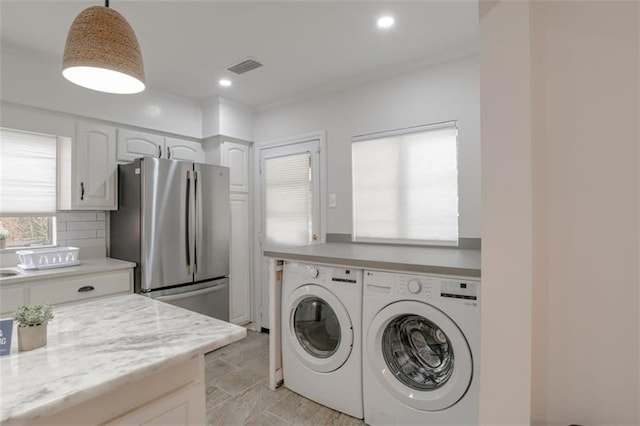 laundry area with independent washer and dryer