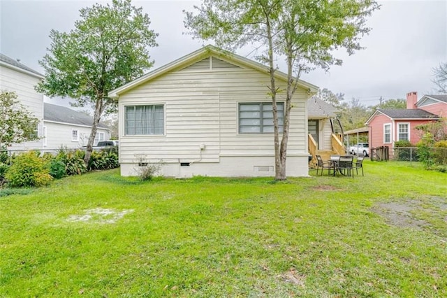 rear view of property with a lawn