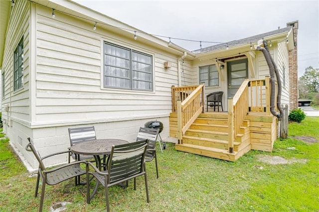 rear view of property with a yard