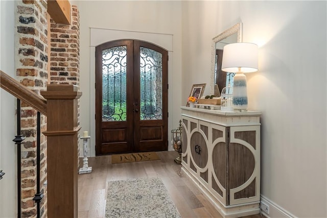 foyer with wood finished floors and french doors