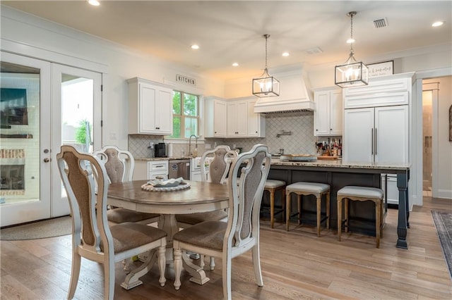 dining room with light wood-style floors and recessed lighting
