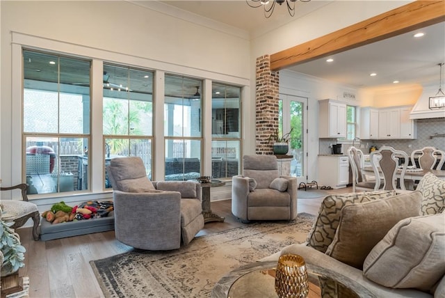 living room with recessed lighting, light wood finished floors, and crown molding