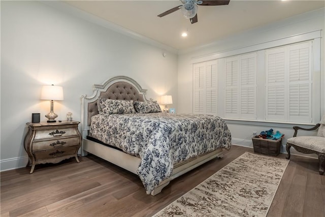 bedroom featuring ornamental molding, baseboards, a ceiling fan, and wood finished floors