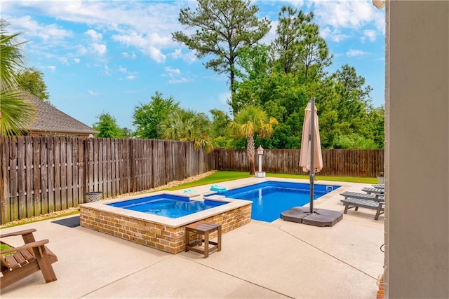 view of swimming pool featuring a fenced backyard, a patio, and a pool with connected hot tub