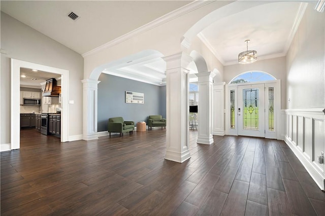 4072 Fenwick Loop, Mobile, AL 36619 - foyer featuring decorative columns, dark wood finished floors, ornamental molding, and arched walkways