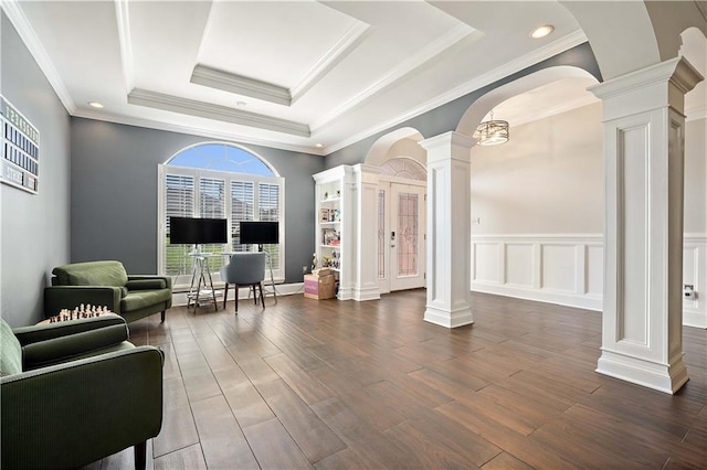 4072 Fenwick Loop, Mobile, AL 36619 - living area featuring decorative columns, a raised ceiling, dark wood-style flooring, crown molding, and arched walkways