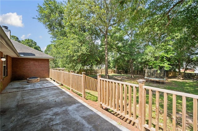 4072 Fenwick Loop, Mobile, AL 36619 - fenced backyard featuring a trampoline and a patio