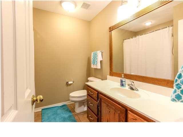 full bathroom with visible vents, toilet, vanity, tile patterned flooring, and baseboards