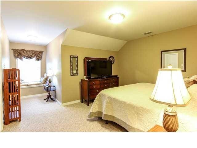 bedroom featuring visible vents, vaulted ceiling, light carpet, and baseboards