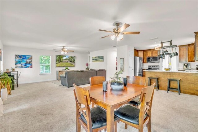 1933 Wildwood Pl, Mobile, AL 36609 - dining area featuring baseboards, ceiling fan, and light carpet