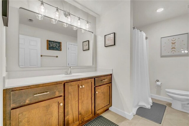 1933 Wildwood Pl, Mobile, AL 36609 - bathroom with toilet, visible vents, tile patterned flooring, and vanity