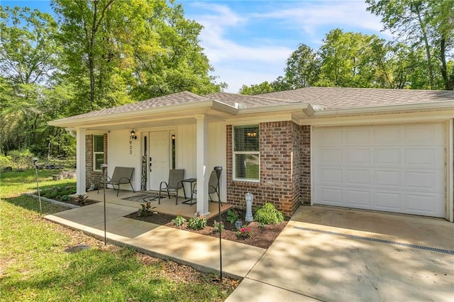 1933 Wildwood Pl, Mobile, AL 36609 - ranch-style house featuring covered porch, driveway, brick siding, an attached garage, and a shingled roof