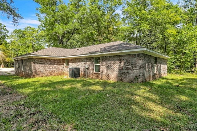 1933 Wildwood Pl, Mobile, AL 36609 - exterior space featuring a lawn, brick siding, and cooling unit