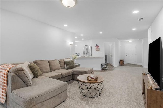 living area with light carpet, baseboards, visible vents, and recessed lighting