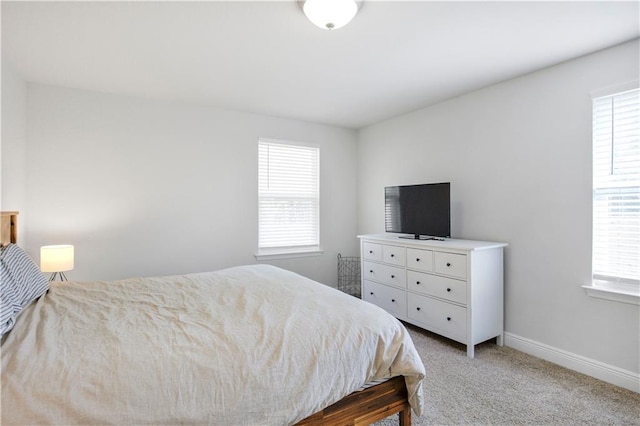 carpeted bedroom featuring baseboards