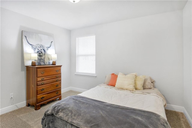 bedroom with carpet and baseboards