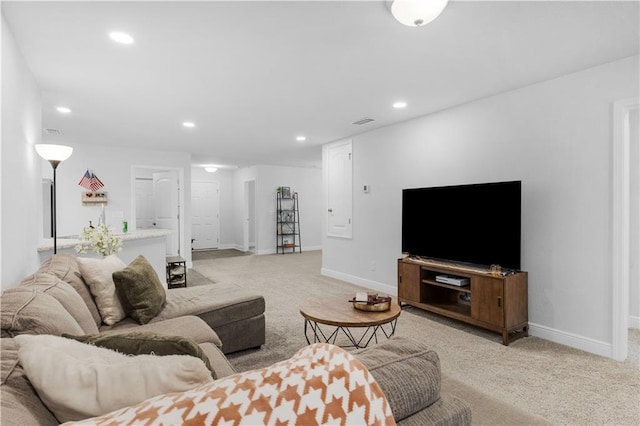 living room with recessed lighting, visible vents, baseboards, and light colored carpet