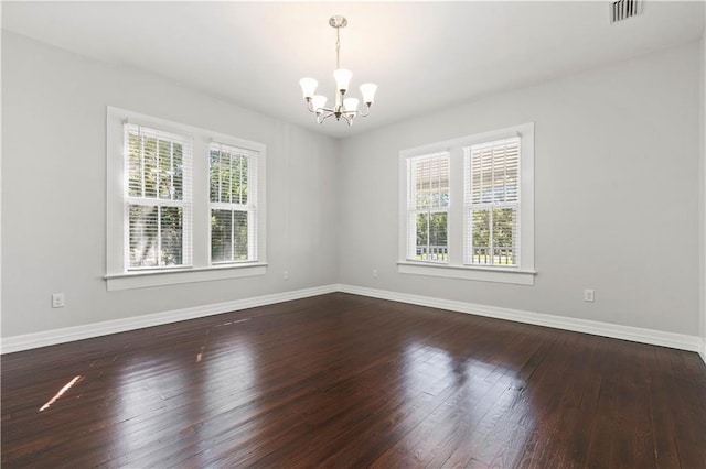 unfurnished room with a chandelier and hardwood / wood-style flooring