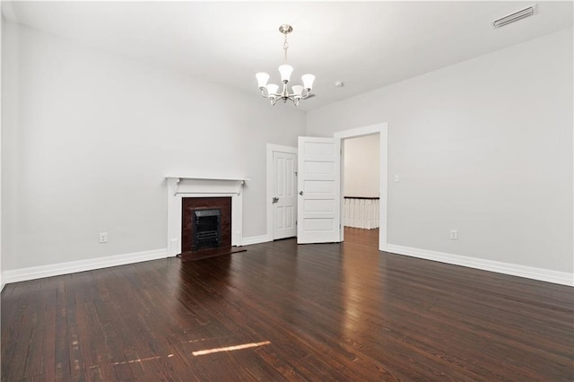 unfurnished living room featuring a notable chandelier and hardwood / wood-style floors