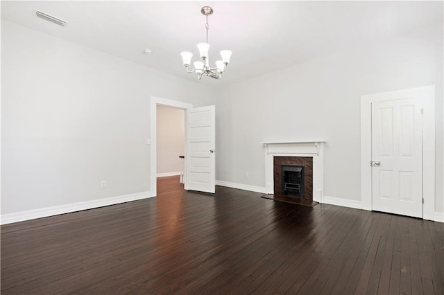 unfurnished living room with a chandelier, wood-type flooring, and a premium fireplace