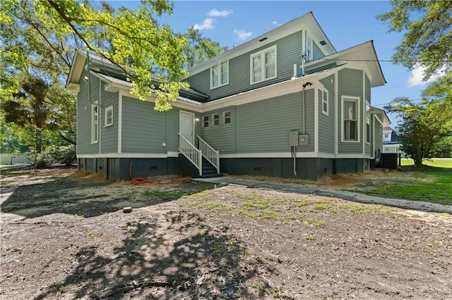 rear view of property with central AC