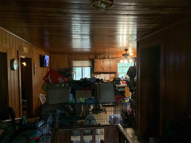 miscellaneous room with wood walls and ceiling fan