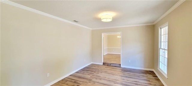 empty room with light hardwood / wood-style flooring and crown molding