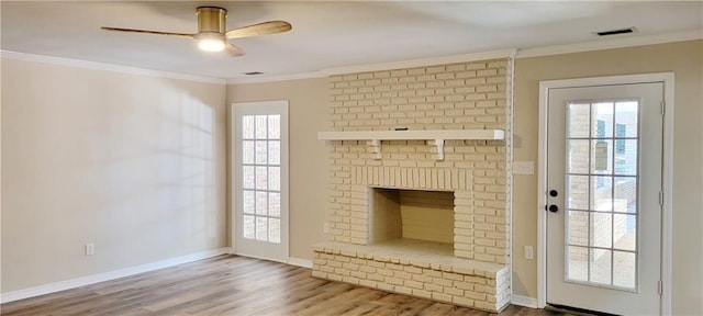 unfurnished living room featuring a fireplace, ceiling fan, hardwood / wood-style floors, and ornamental molding