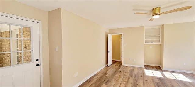 doorway with ceiling fan and light hardwood / wood-style flooring