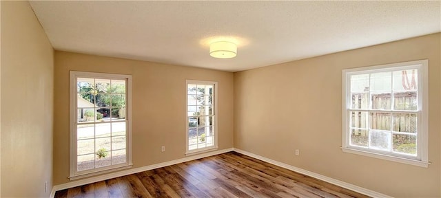 empty room with dark wood-type flooring