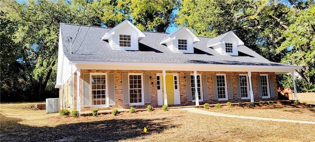 view of front of property with a porch and central AC