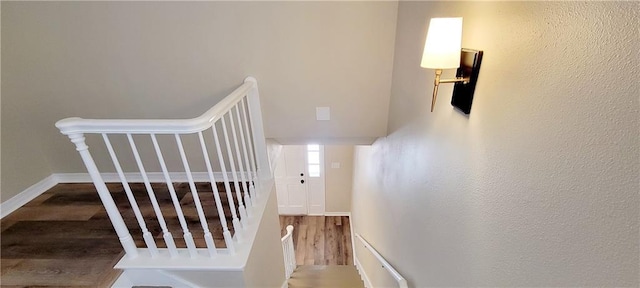 stairs featuring hardwood / wood-style flooring