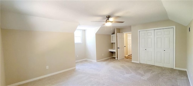 bonus room featuring ceiling fan, light colored carpet, and lofted ceiling