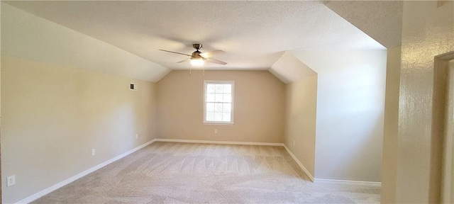 bonus room featuring ceiling fan, light colored carpet, and vaulted ceiling