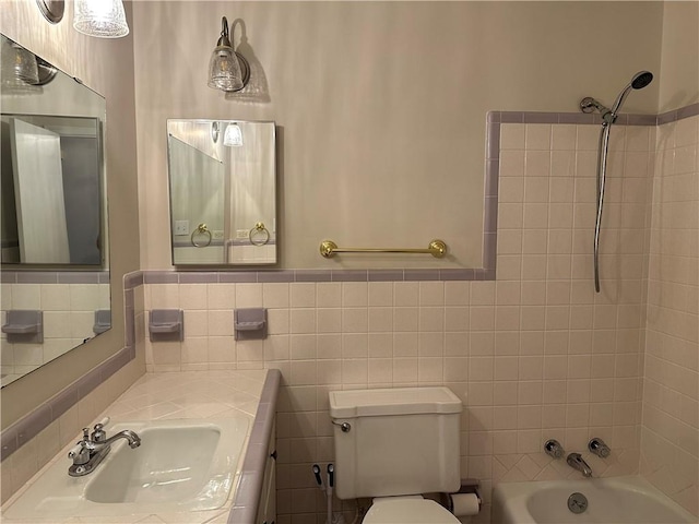 full bathroom featuring vanity, toilet, and tiled shower / bath