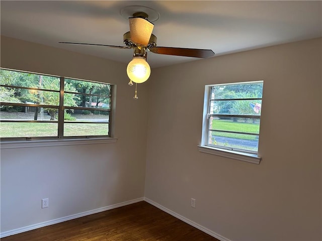 spare room with ceiling fan and dark wood-type flooring