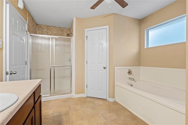 bathroom with vanity, tile patterned floors, ceiling fan, a textured ceiling, and shower with separate bathtub