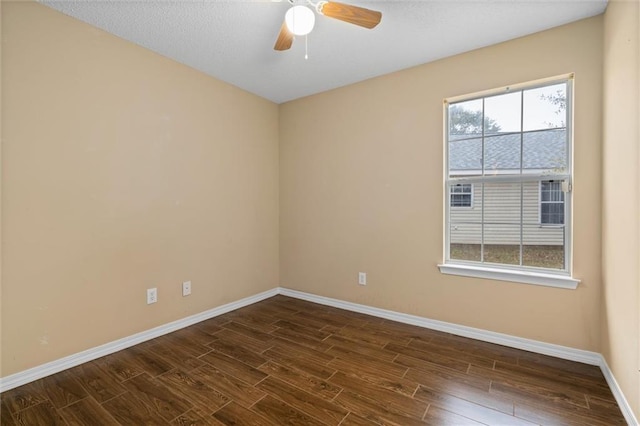 empty room featuring a textured ceiling, dark hardwood / wood-style flooring, and ceiling fan