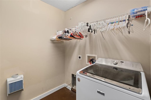 laundry room with washer / clothes dryer and a textured ceiling