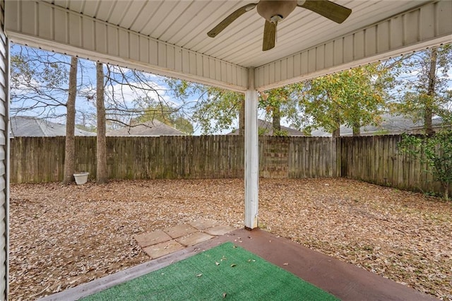 view of yard with ceiling fan and a patio