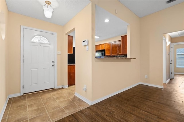 foyer entrance with light hardwood / wood-style flooring