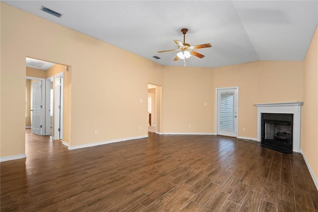 unfurnished living room with dark hardwood / wood-style floors, ceiling fan, lofted ceiling, and a tiled fireplace