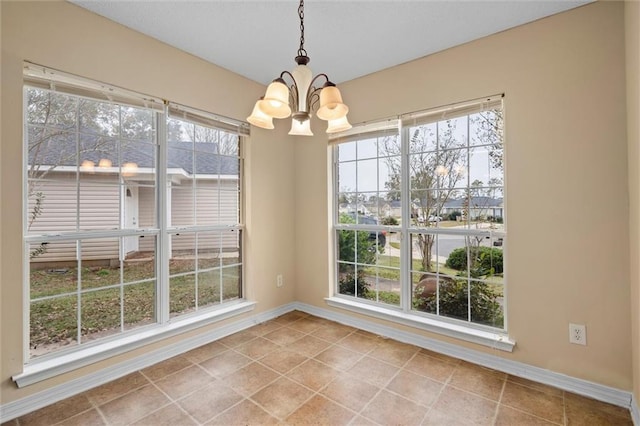 unfurnished dining area featuring light tile patterned floors and a chandelier