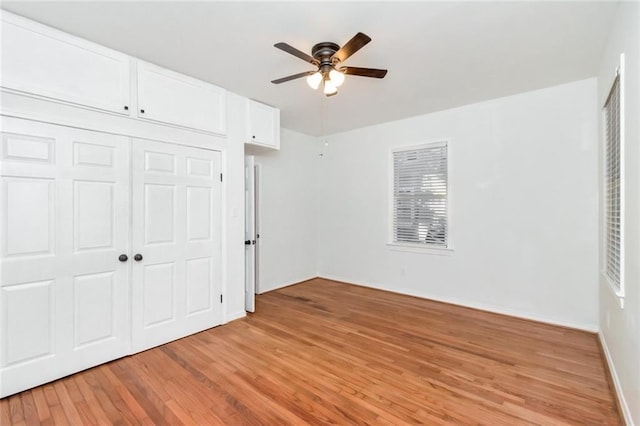 unfurnished bedroom featuring ceiling fan, a closet, and light hardwood / wood-style floors