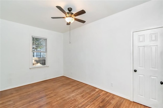 spare room featuring ceiling fan and hardwood / wood-style flooring