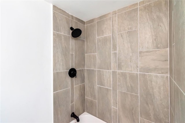 interior details with tiled shower / bath combo