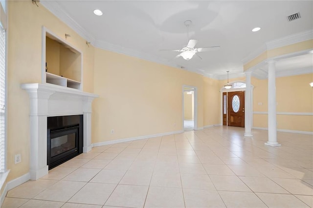 unfurnished living room with crown molding, ceiling fan, and ornate columns