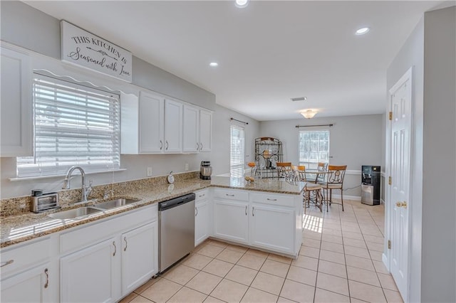 kitchen featuring sink, dishwasher, white cabinets, and kitchen peninsula